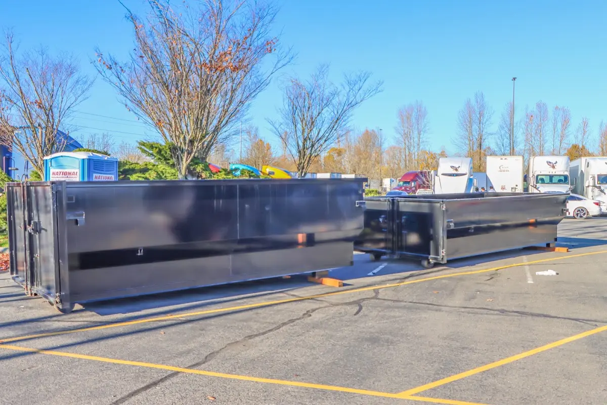 Professional dumpster rental service with roll-off container on residential driveway in Viera West